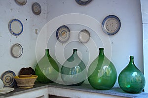 Old demijohns and wall plates