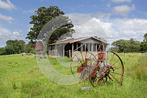 Old derelict farm shed and rusty cart wheels at Benandarah