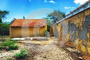 Old derelict house with trees and garden on island Bonaire