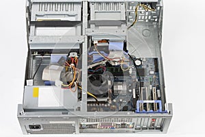 Old desktop computer, inside floppy disk drive, cd drive, hard  disk drive, main board , power supply unit. PC without upper board