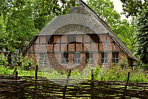 An old desolate and abandoned farmhouse lies vacant and looks like a haunting house.