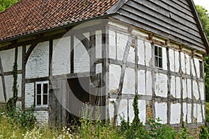 An old desolate and abandoned farmhouse lies vacant and looks like a haunting house.