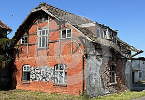 Old desolate red brick house, ruin and out of use architecture