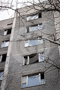 Old destroyed abandoned high rise building with broken windows in ghost town Pripyat, Chernobyl Exclusion Zone, Ukraine. Vertical