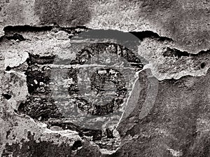 Old destroyed brick wall. Dark brickwork in background of crumbling plaster. Grunge background.