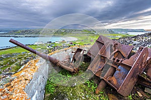 Old destroyed cannon in Hamningberg coastal fort, German military vestige of 2d World War pastime. The abandoned fishersâ€™