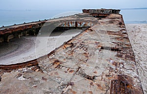 Old destroyed concrete barge abandoned on the sandy Kinburn Spit