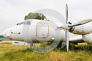 Old destroyed dismantled and abandoned aircraft in the field. Plane crash.