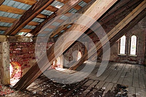 Old destroyed wooden brick attic roof