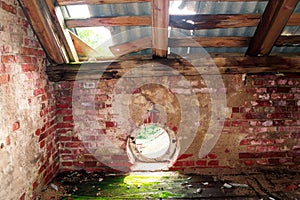 Old destroyed wooden brick attic roof