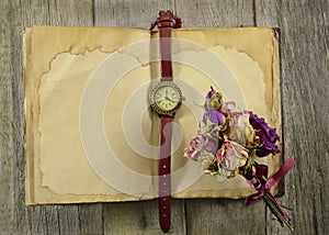 Old diary with clock and flowers