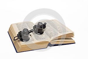 Old dictionary and magnifying glasses