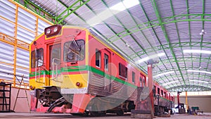 An old diesel train is parked in garage awaiting to maintenance and improvement wheels and suspension system