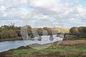 Old dilapidated bridge over the autumn Russian river Khoper