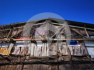 Old dilapidated house facade and blue sky