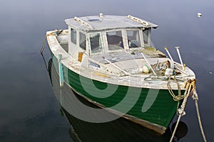 An old dilapidated marine ply cruiser with an inboard diesal eng