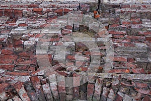 Old dilapidated red brick wall