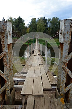 Old dangerous dilapidated suspension bridge photo