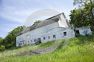 Old, dilapidated white barn in the midwest