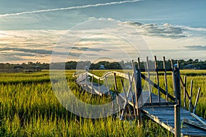 old dilapidated wooden dock in the marshgrass and inlet of Palweys Island in South Carolina photo