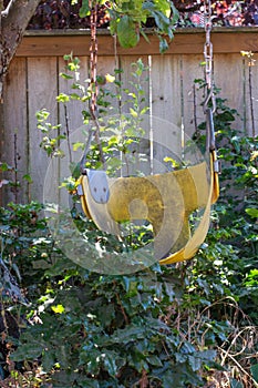 Old dilapidated yellow swing