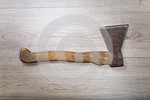 Old and dirty axe on wood background