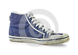 Old and dirty blue canvas sneakers on white background