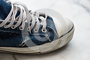 Old dirty blue sneaker. Teenager fashion