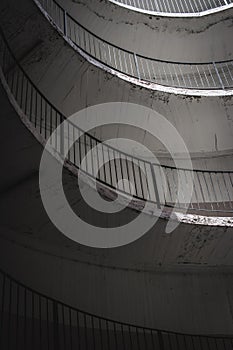 Old and dirty car parking area with spiral stairs walking road