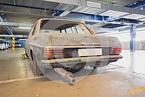 an old dirty car in a parking garage