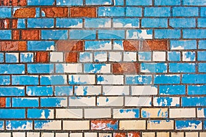 Old dirty colored brick wall texture with blue peeling paint background