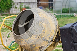 Old dirty concrete mixer close up