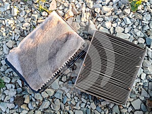 An old dirty filter out of car. Replacing the air filter