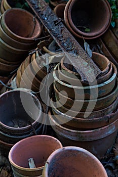 Old dirty flower pots stacked in garden