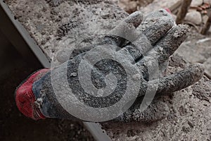 Old and dirty leather gloves on house construction.