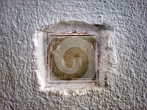 Old dirty light switch on old cracked wall