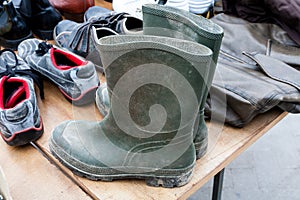 Old dirty pair of gumboots with sneakers