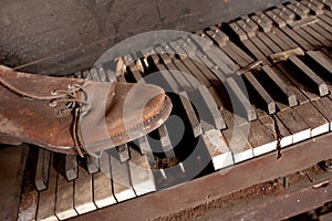Old Dirty Piano With Old Leather Shoe