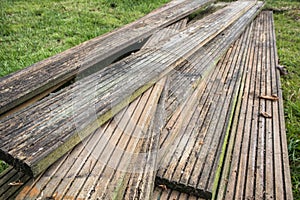Old dirty reclaimed wooden decking planks