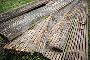 Reclaimed wooden decking planks on grass photo