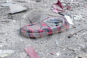 Old, dirty red and black slipper, discarded