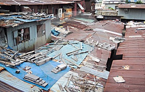 Old dirty rooftop house with messy wood stick on top