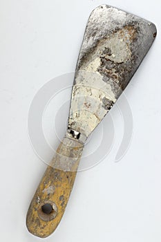 Old dirty scraper isolated on white
