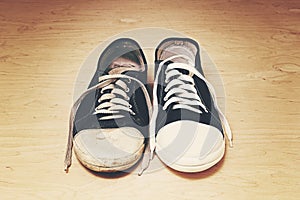 Old dirty shabby and new clean unworn sneakers