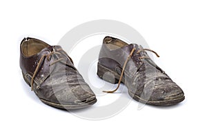 Old dirty shabby shoes on a white background