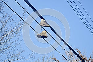 Old dirty shoes thrown over power lines