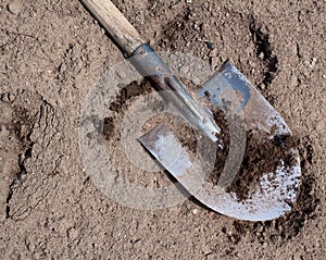 Old dirty shovel on the dry ground