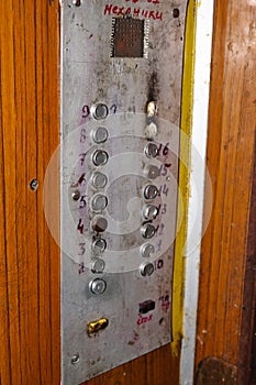 Old dirty and stained Ðµlevator with metal buttons