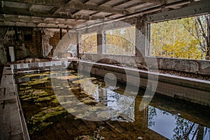 Old dirty swimming pool at the gym in the abandoned school building located in the Chernobyl ghost town