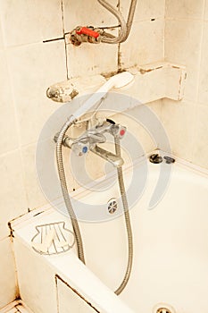 Old dirty tap on the bath